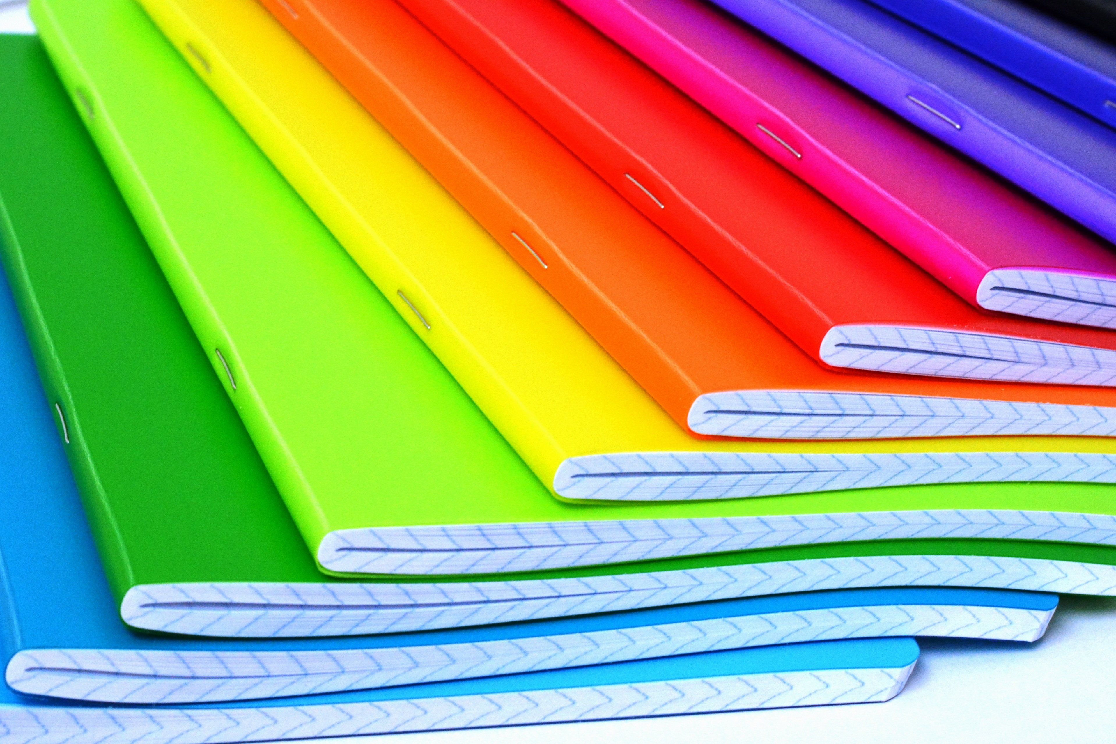 Colored notebooks arranged in a fan.
